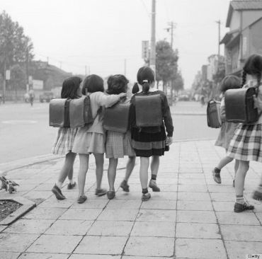 circa 1950: Japanese schoolchildren on their way to school in Tokyo. (Photo by Orlando /Three Lions/Getty Images)